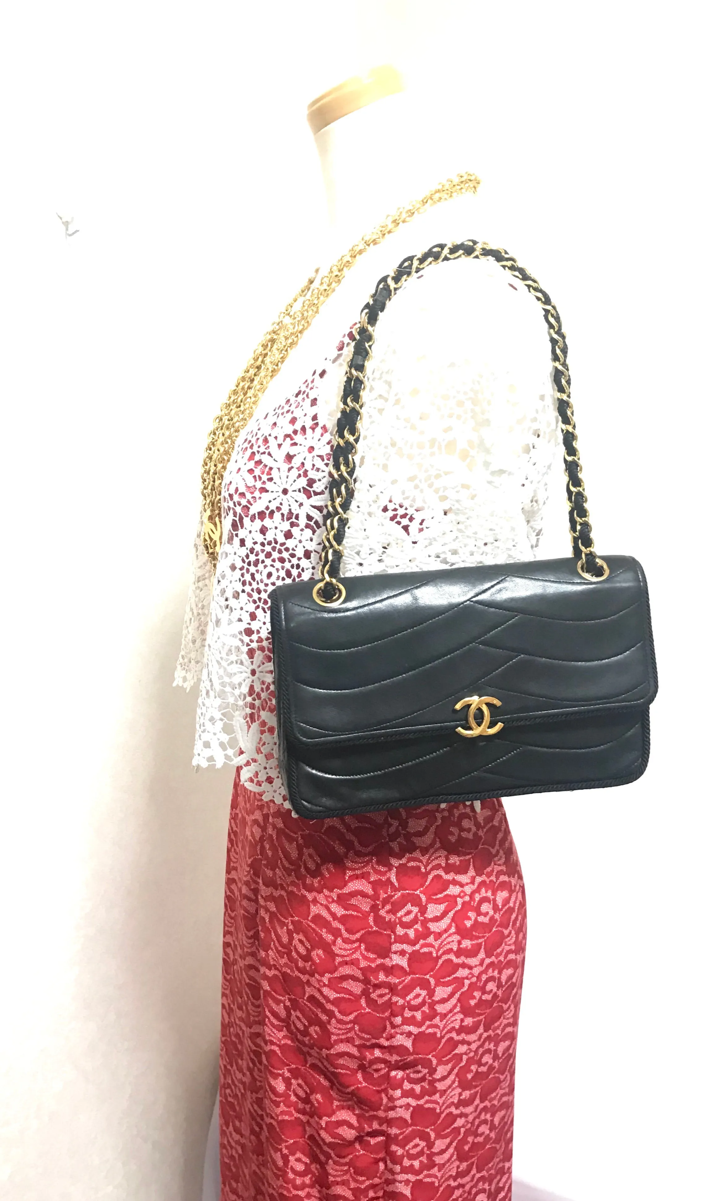 80's vintage Chanel black 2.55 shoulder bag with wavy stitches and rope strings and gold chain strap. Very rare piece from the era