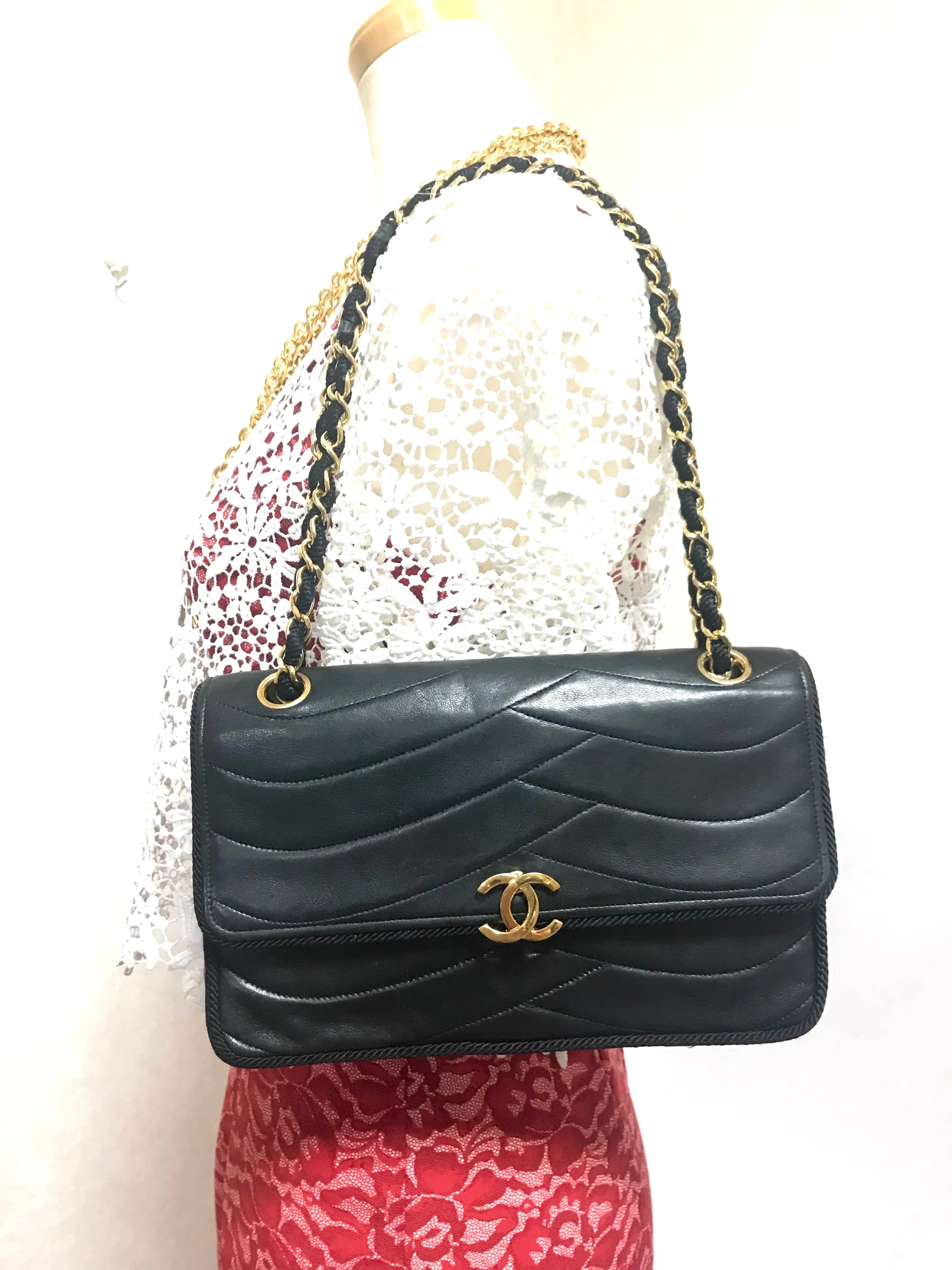 80's vintage Chanel black 2.55 shoulder bag with wavy stitches and rope strings and gold chain strap. Very rare piece from the era