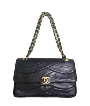 80's vintage Chanel black 2.55 shoulder bag with wavy stitches and rope strings and gold chain strap. Very rare piece from the era