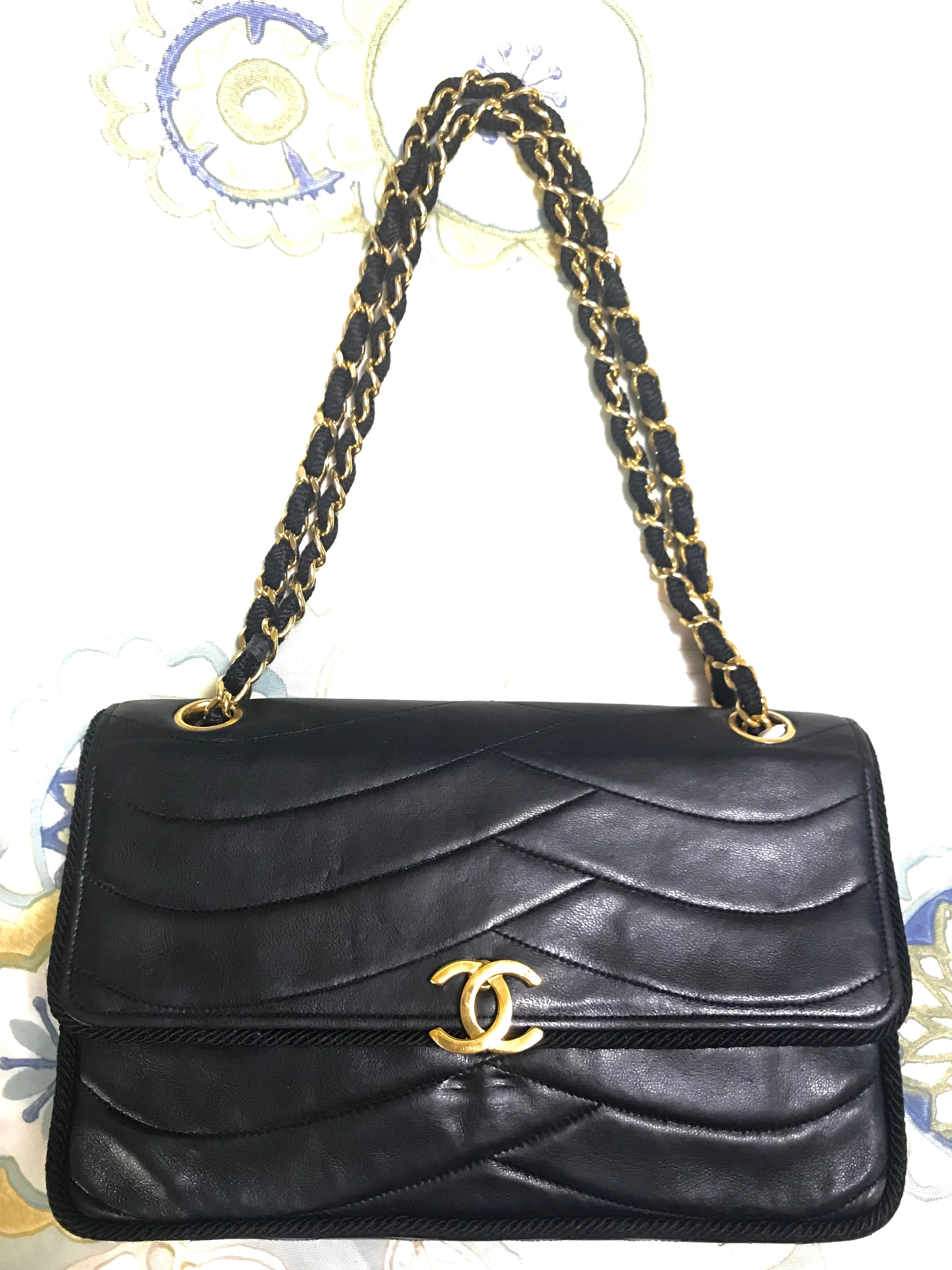 80's vintage Chanel black 2.55 shoulder bag with wavy stitches and rope strings and gold chain strap. Very rare piece from the era