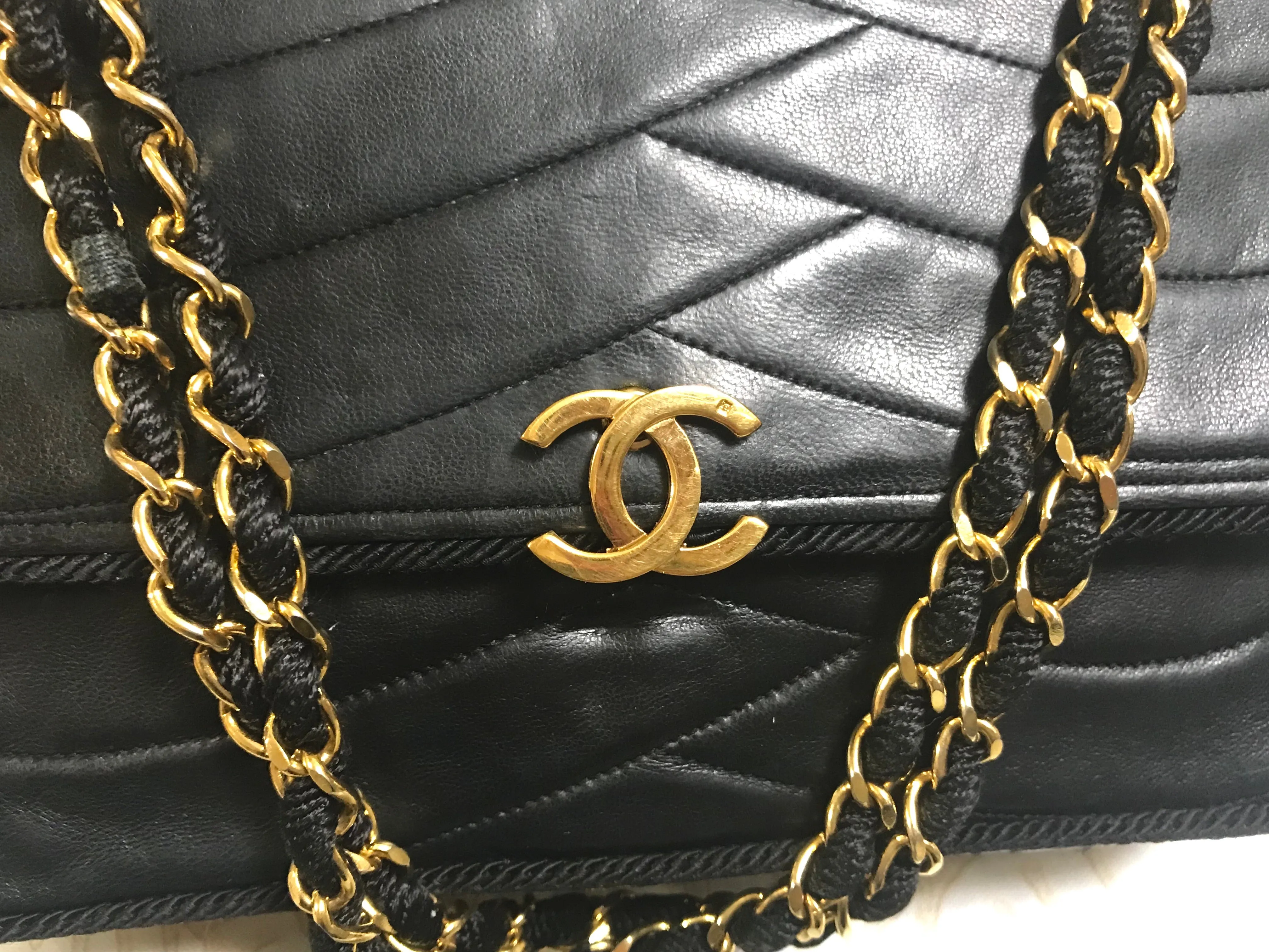 80's vintage Chanel black 2.55 shoulder bag with wavy stitches and rope strings and gold chain strap. Very rare piece from the era