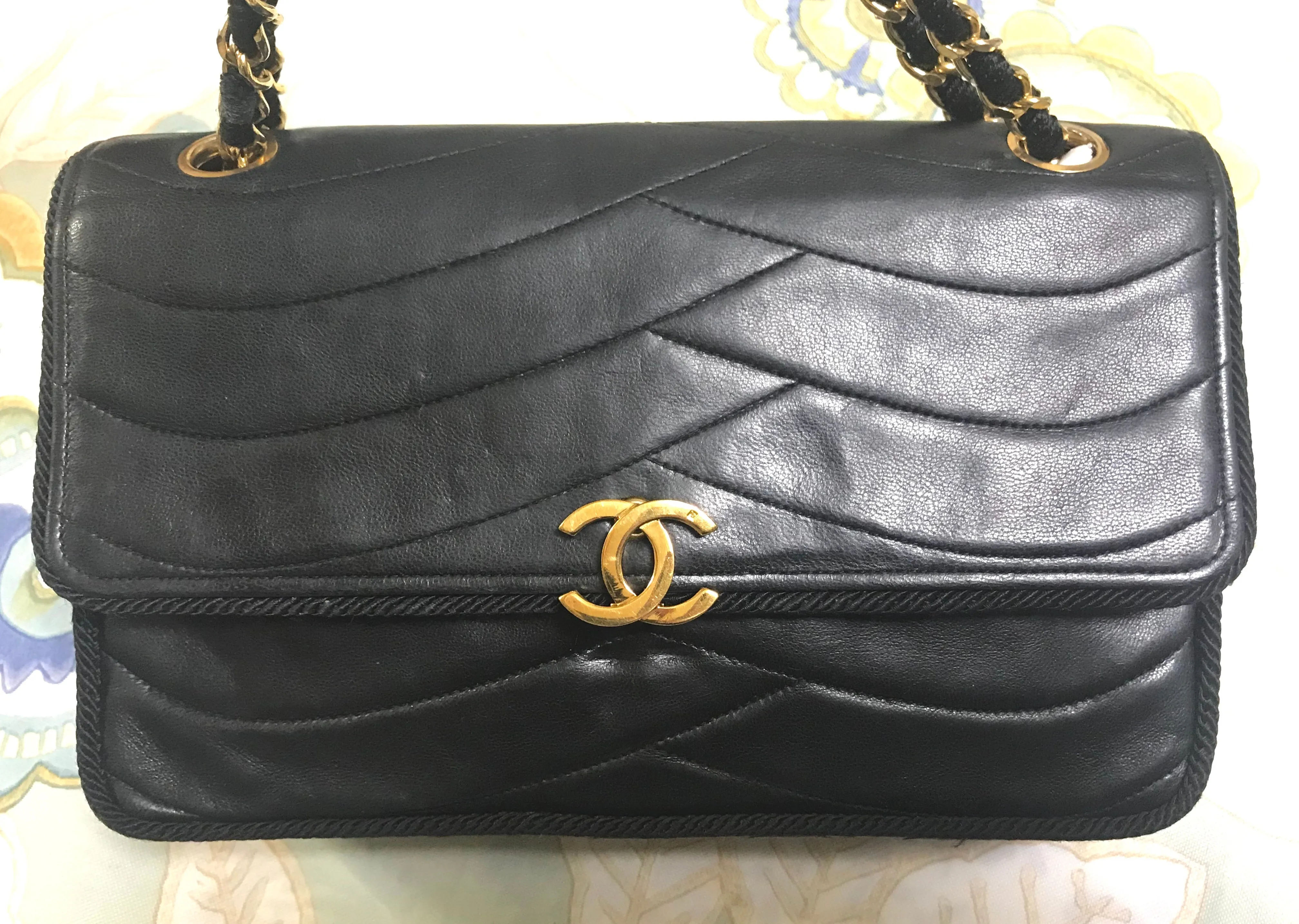 80's vintage Chanel black 2.55 shoulder bag with wavy stitches and rope strings and gold chain strap. Very rare piece from the era