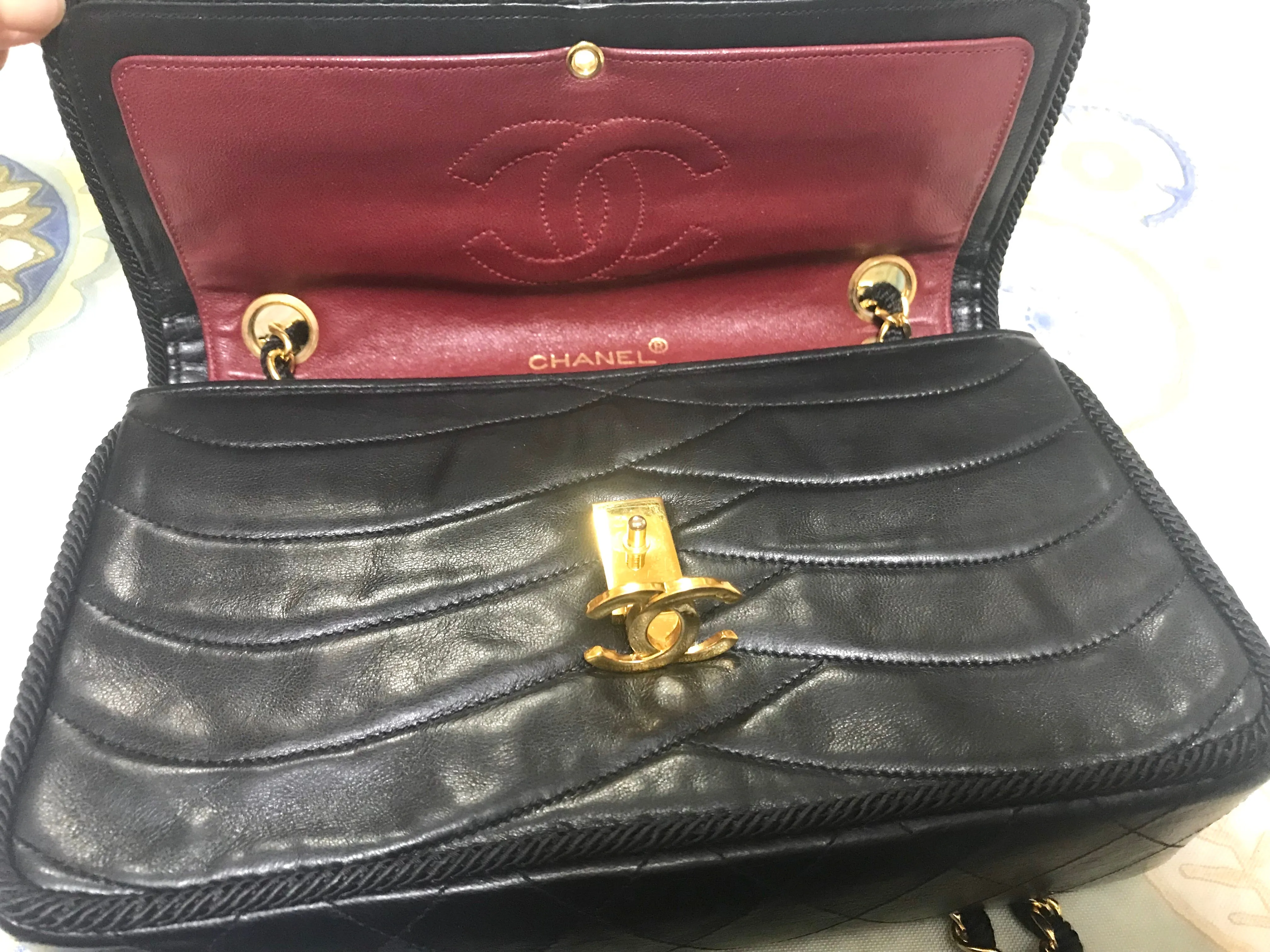 80's vintage Chanel black 2.55 shoulder bag with wavy stitches and rope strings and gold chain strap. Very rare piece from the era