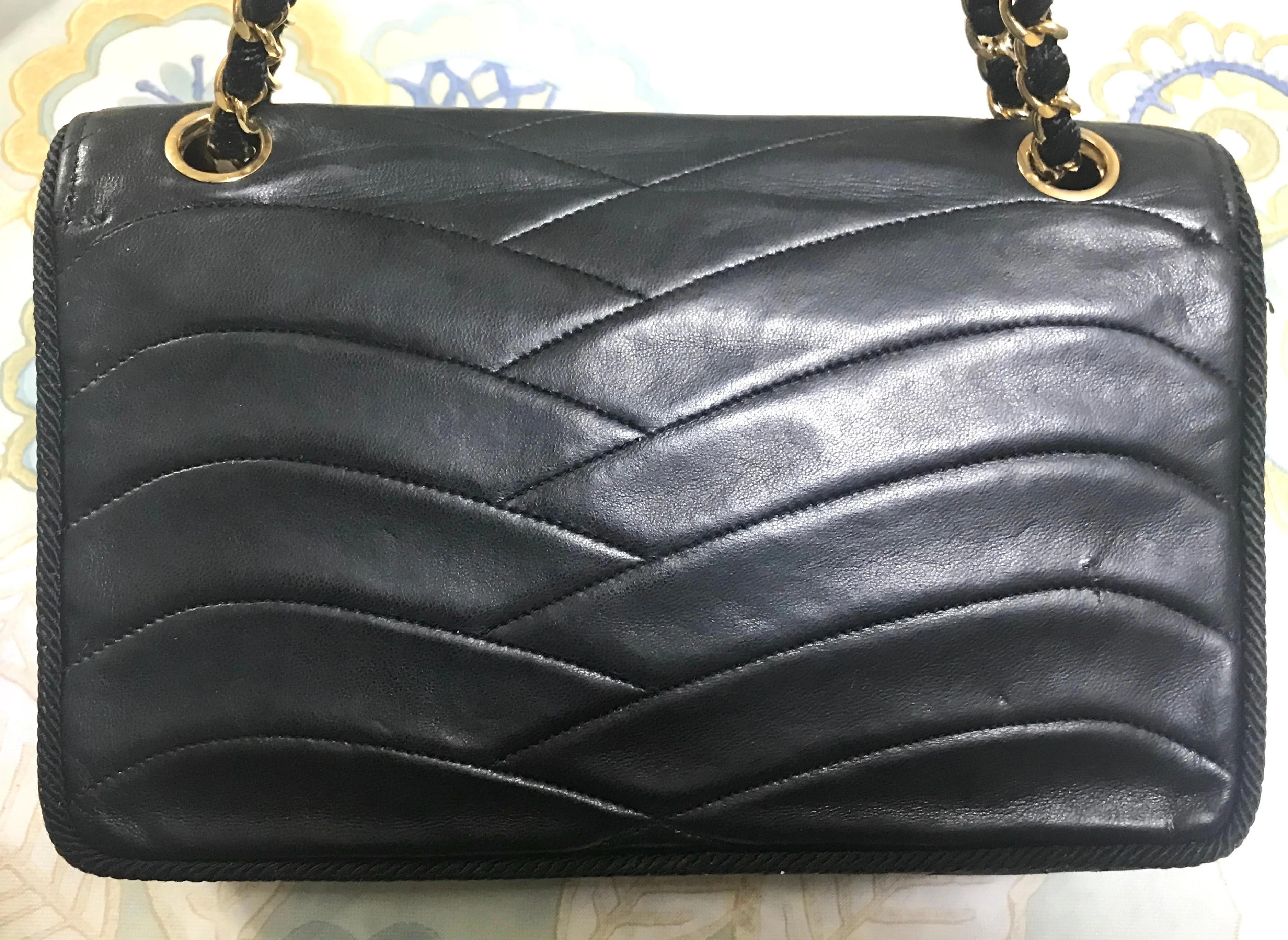 80's vintage Chanel black 2.55 shoulder bag with wavy stitches and rope strings and gold chain strap. Very rare piece from the era