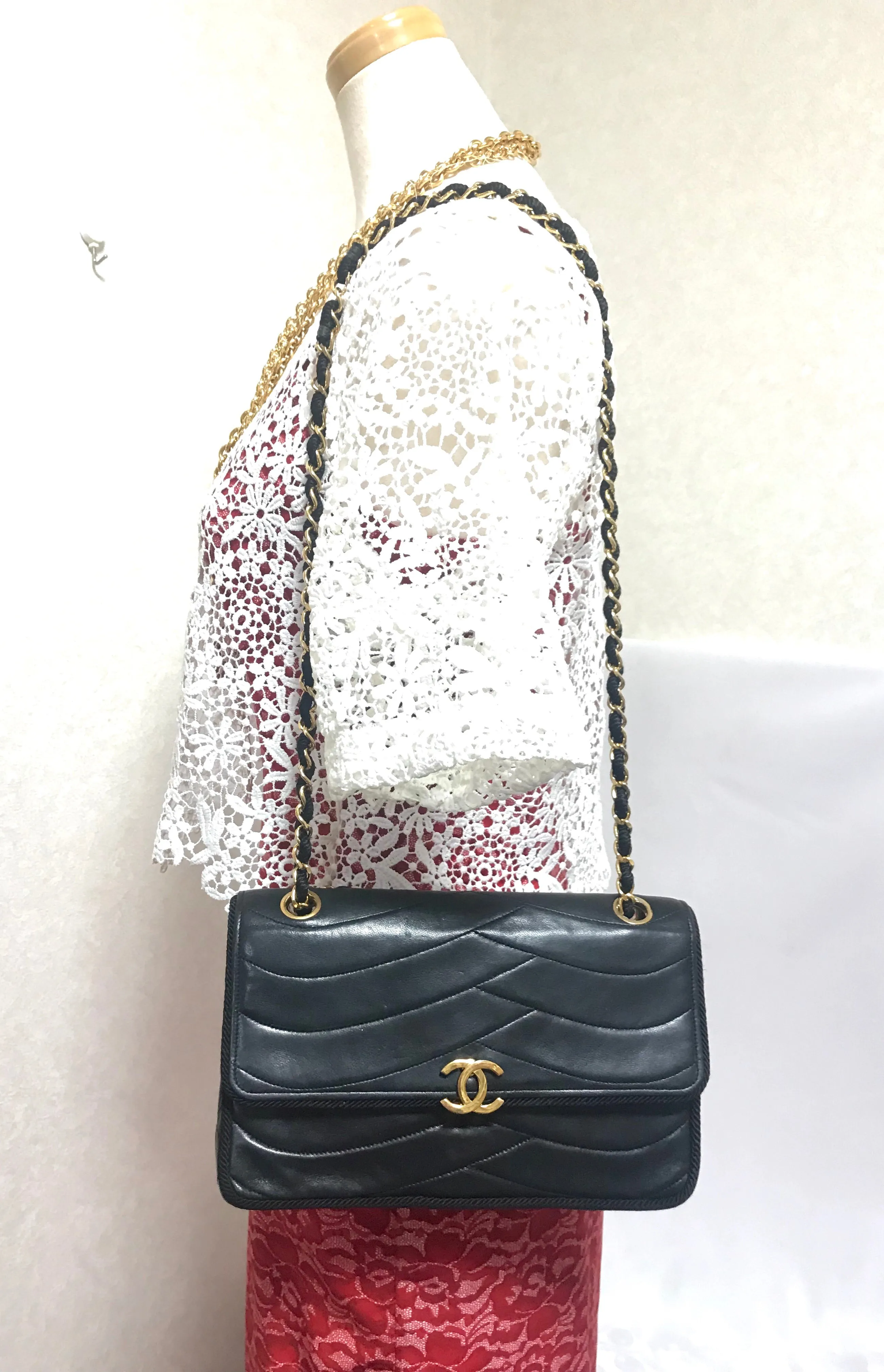 80's vintage Chanel black 2.55 shoulder bag with wavy stitches and rope strings and gold chain strap. Very rare piece from the era