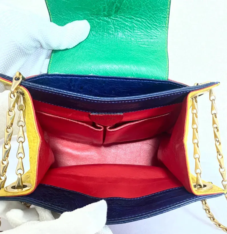 Vintage Celine genuine ostrich shoulder bag with gold tone chains and red, orange, blue, green, and yellow patchwork design. 050410ac1