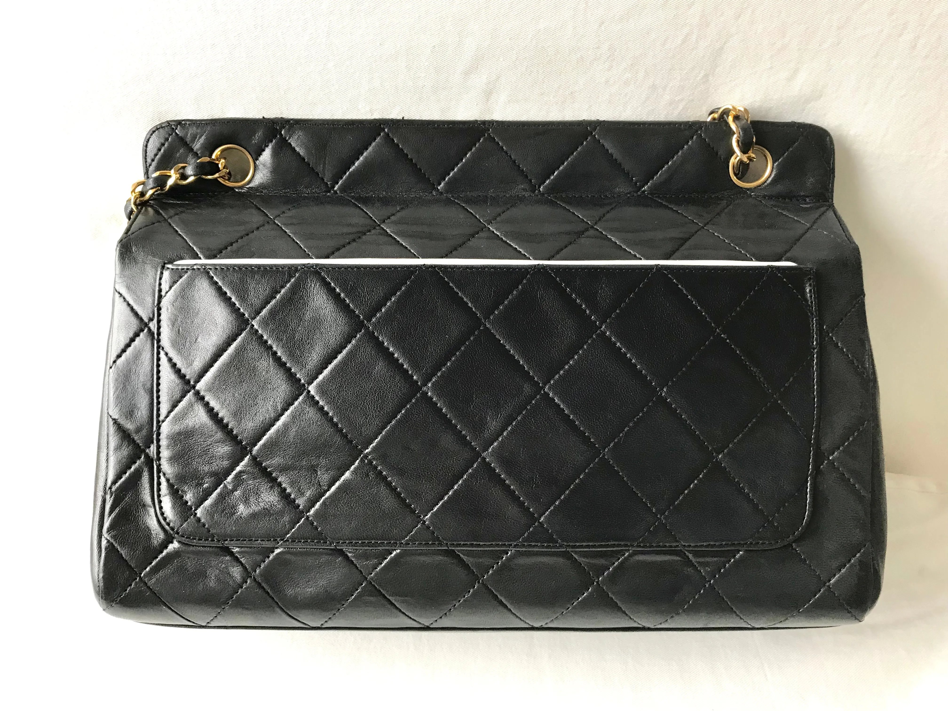 Vintage Chanel black leather 2.55 chain large shoulder bag with white trimming edge and a matching pouch. 0403284