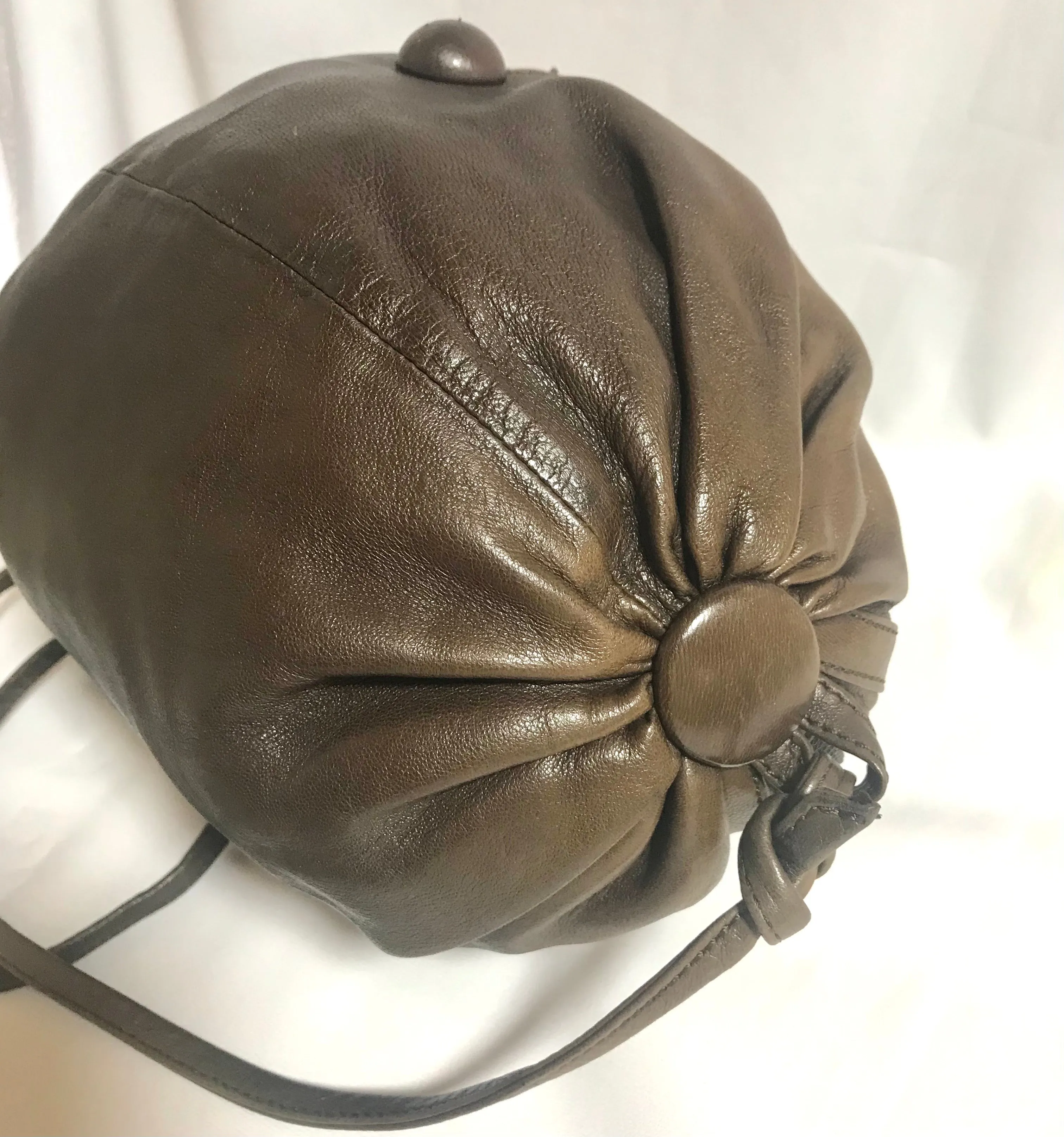 Vintage Moschino soft brown leather drum shape shoulder bag with iconic Question marks. Moschino by Redwall. Made in Italy. 060724r1 Moschino by Redwall. Made in Italy.